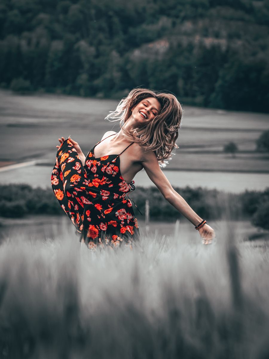 Mujer bailando libremente al aire libre, representando la energía inquieta y curiosa del Ascendente en Géminis