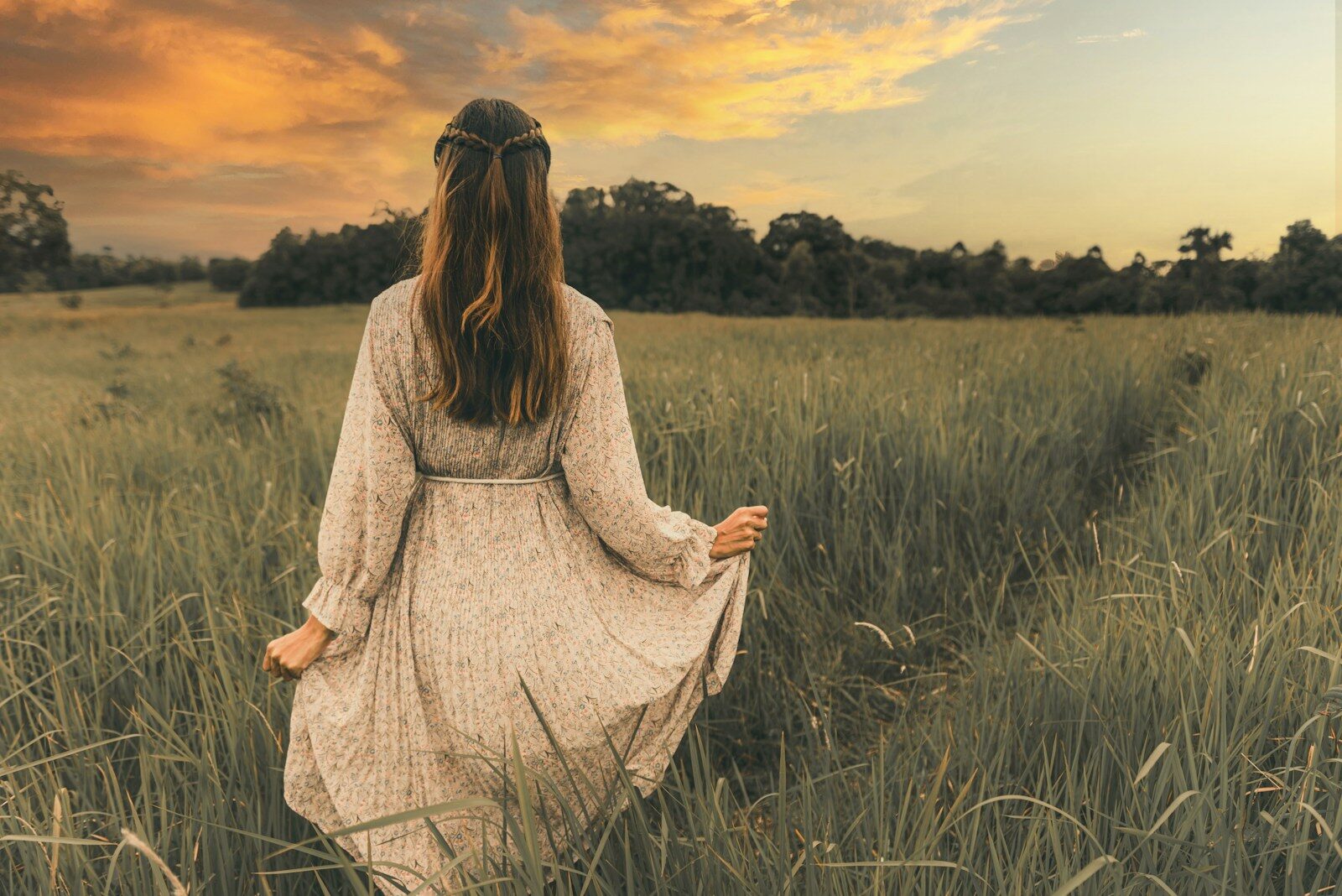Mujer caminando sola al atardecer, reflexionando sobre sí misma